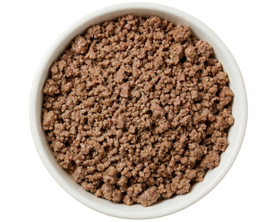 White bowl filled with brown ground cat food on a transparent background