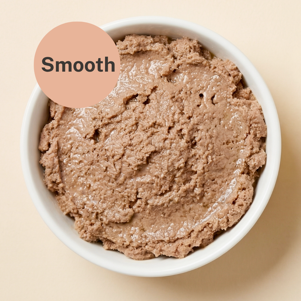 Bowl of smooth wet cat food, beige-brown pate texture