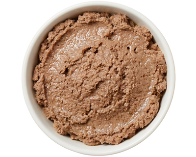 White bowl filled with brown smooth textured cat food on a transparent background